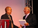 Barry Barnes (left) hands a key customer award to Bob King of King Lifting at the opening of Terex CraneÃ¢â‚¬â„¢s new UK facility in Long Crendon, in 2008